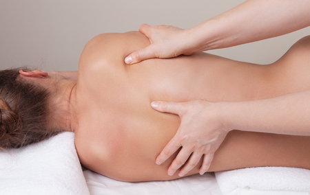 Deep tissue massage on the woman's backの写真素材