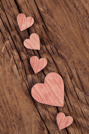 Pink wooden hearts  on a very old  woodの写真素材