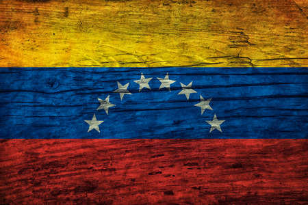 Vintage flag of Venezuela on a wooden surfaceの写真素材