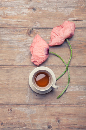 Enjoyable cup of tea with beautiful poppy flowersの写真素材