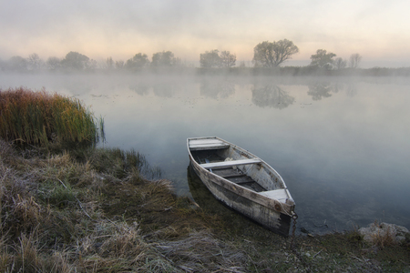 Lonely boat by the riverの写真素材
