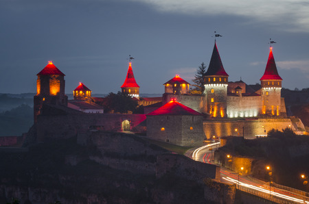 Panoramic view of the old fortress in Kamyanets-Podilsky, Ukraine. The towers of the fortress are illuminated with bright lights.のeditorial素材