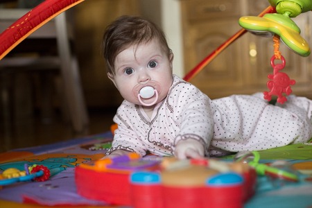 Cute baby girl playing with toy piano.の写真素材