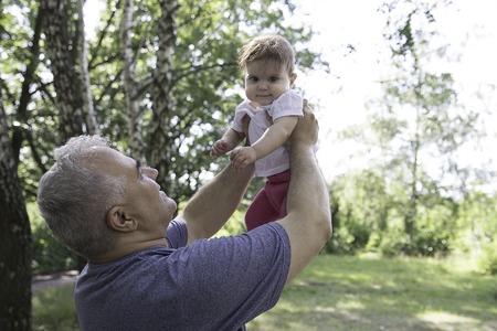 Happy father and cute toddler playing and laughing outside. Family bonding conceptの写真素材