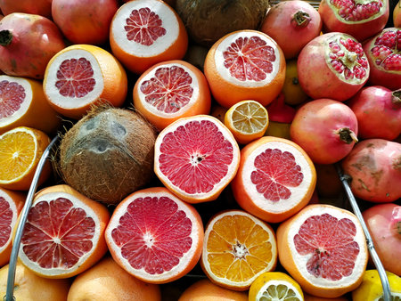 Fruit at street market. Grapefruit, coconuts, oranges, pomegranates and lemons.