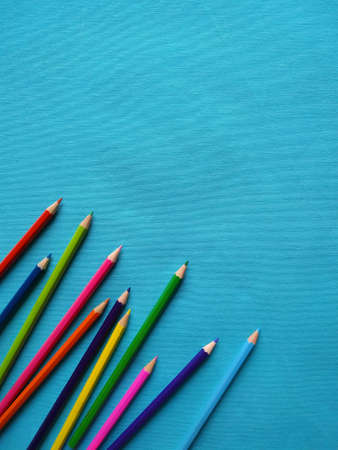 Back to school concept. Top vertical view of color pencils on blue background.の写真素材