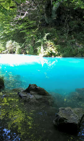 Idyllic river landscape with rocks and turquoise water at Urederra National Park in Navarra. North of Spain nature and travel destinations.の写真素材