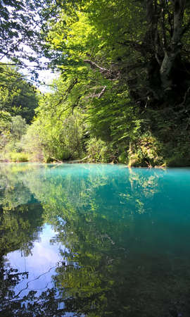 Idyllic river landscape with turquoise water reflection at Urederra National Park in Navarra. North of Spain nature and travel destinations.の写真素材