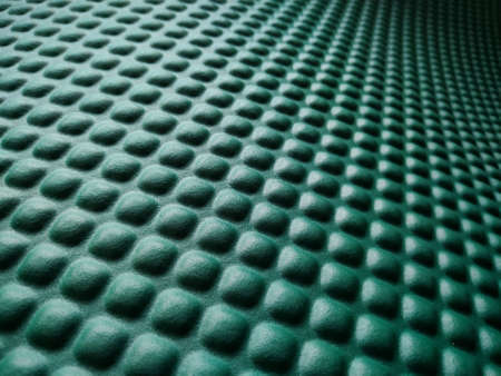 Green rubber mat texture inside a gym. Perspective view of fitness floor background with copy space.の写真素材
