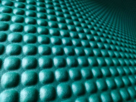 Green rubber mat texture closeup inside a gym. Perspective horizontal view of fitness floor background with copy space.の写真素材