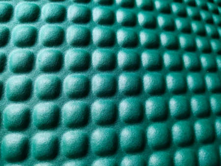 Green rubber mat texture inside a gym. Perspective horizontal view of fitness floor background with copy space.の写真素材