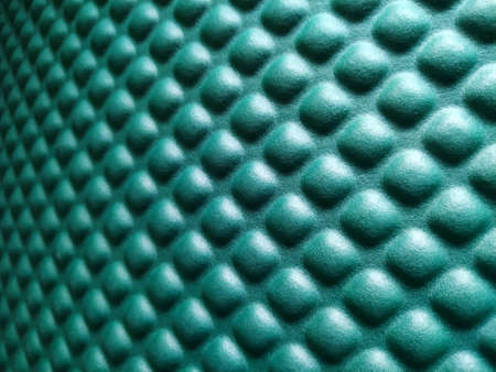 Green rubber mat texture inside a gym. Fitness floor background with copy space.の写真素材
