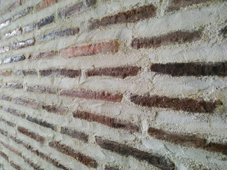 Old brick wall texture background. Perspective view of masonry wall made of red bricks and white lime mortarの写真素材