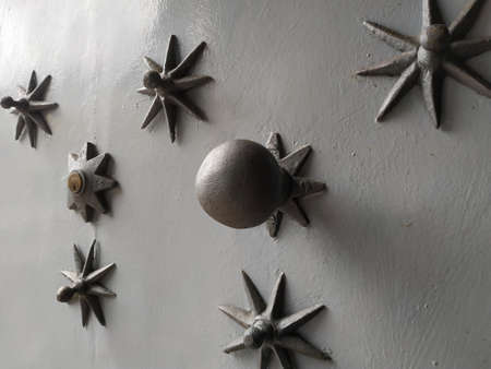 Old village front door closeup with stars pattern. Detail of the lock and gray paint.の写真素材