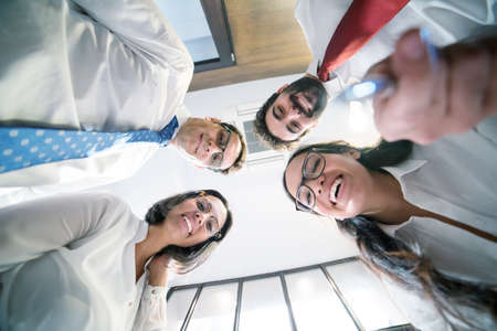 Happy successful business teamwork at the office.の写真素材