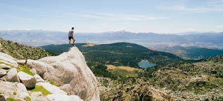 Young man on top of the hill enjoying the view.の写真素材