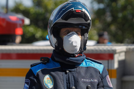 A Coruna-Spain.Portrait of A Coru? ? a local police wearing a motorcycle helmet and mask due to the...