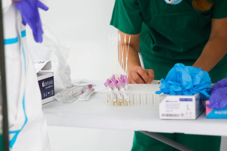 A Coruna-Spain -August 18, 2020: A health worker uses a PCR test (mouth and nasal swab) on a person...