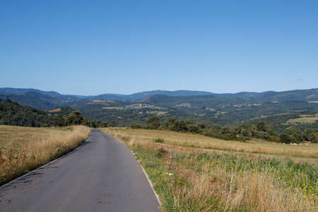 Pastures and morning fog at the top of Sete Carballos in the Mountain range Os Ancares in Lugo, Spainの写真素材