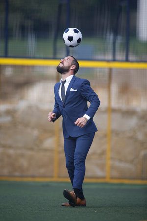 European Football Championship concept. Businessman playing soccer ball.の写真素材