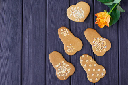 Gingerbread penis and heart shaped cookies on veri peri wooden background.の写真素材