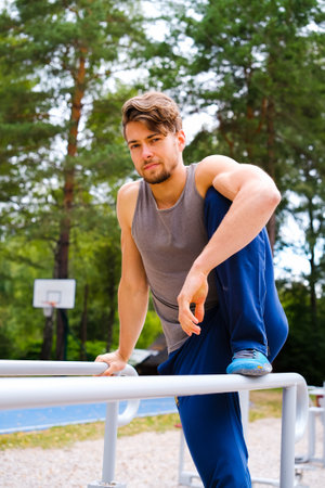 Healthy lifestyle concept Training outdoors Handsome man doing cross fit in parkの写真素材