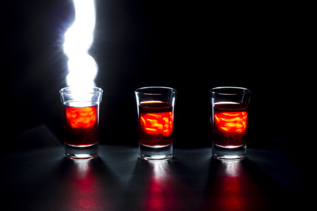 Shot Glass fireball painting with lightの写真素材
