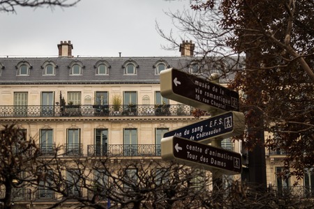 Road signs in front of the typical Parisian buildingのeditorial素材