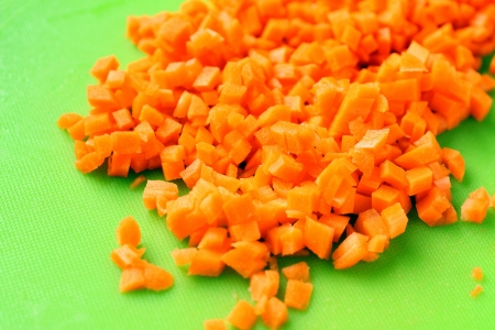 Fresh cut carrot on green boardの写真素材