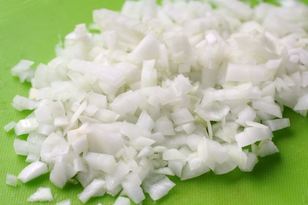 Fresh cut onion on green boardの写真素材