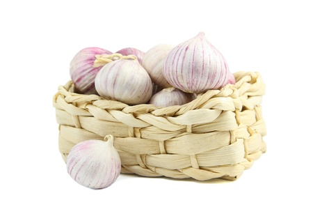 Chinese garlic in a wicker basket  isolated over whiteの写真素材