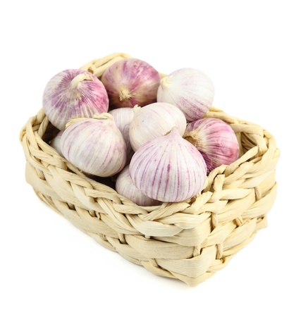 Chinese garlic in a wicker basket  isolated over whiteの写真素材