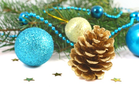 Christmas composition with pinecone and blue ball over whiteの写真素材