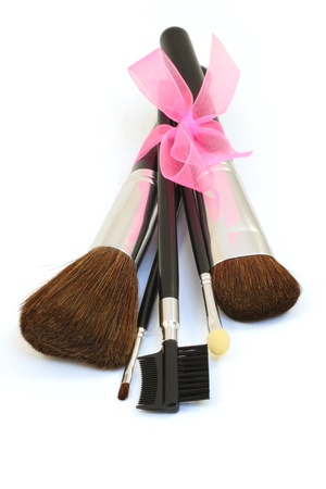 Make-up brushes with pink bow isolated over whiteの写真素材