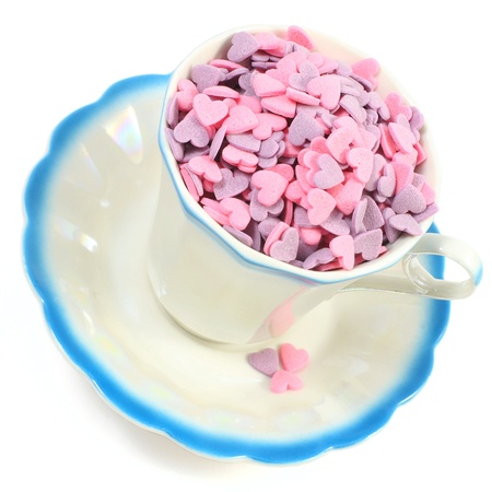 Candy hearts in coffee cup isolated over whiteの写真素材