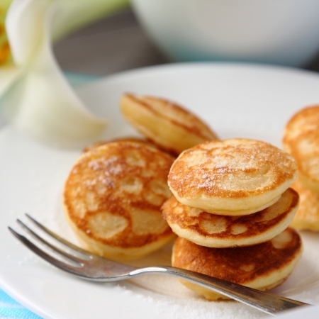 Dutch mini pancakes called poffertjes, sprinkled with powdered sugarの写真素材