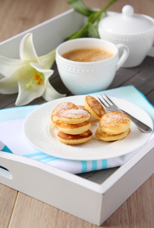 Dutch mini pancakes called poffertjes, sprinkled with powdered sugarの写真素材