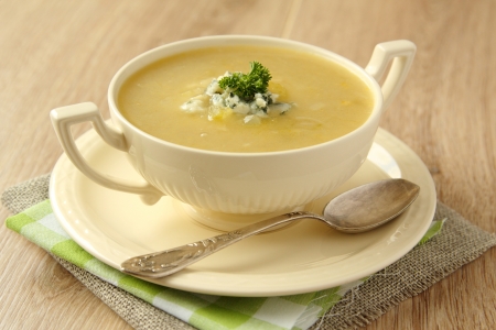 Homemade onion soup with celery and blue cheese on wooden backgroundの写真素材