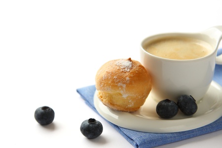 Cup of coffee with profiteroles and blueberriesの写真素材
