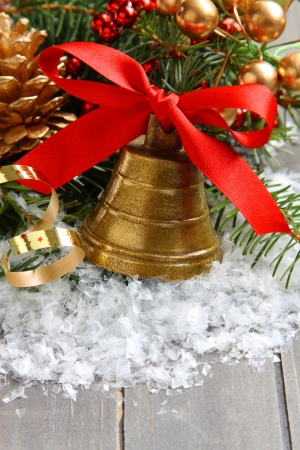Golden bell with red satin ribbon bow and christmas decorationの写真素材