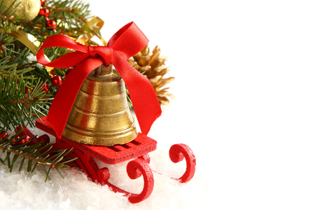 Christmas composition with sleigh and golden bell over whiteの写真素材