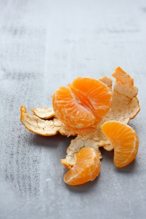 Open fresh mandarin on gray backgroundの写真素材
