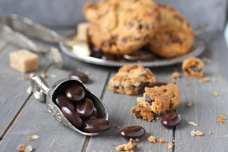 Chocolate candy with chocolate chip cookies on wooden backgroundの写真素材