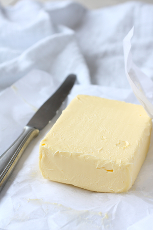 Piece of butter in paper with khifeの写真素材