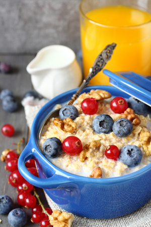 Healthy Tasty Homemade Oatmeal with Berries and glass of juice for Breakfastの写真素材