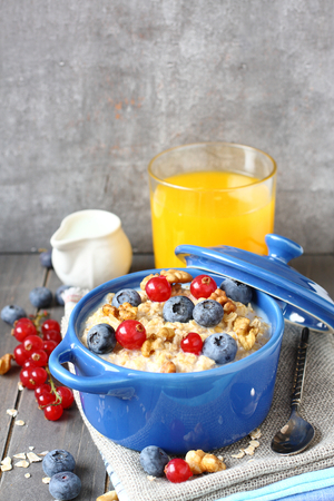 Healthy Tasty Homemade Oatmeal with Berries and glass of juice for Breakfastの写真素材