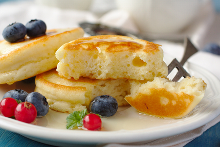 Homemade delicious pancakes with fresh berries and honeyの写真素材