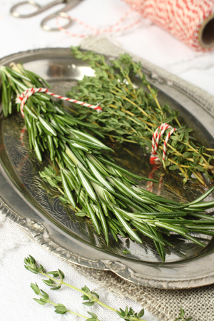 Fresh aromatic herbs rosemary and thyme on metal plateの写真素材