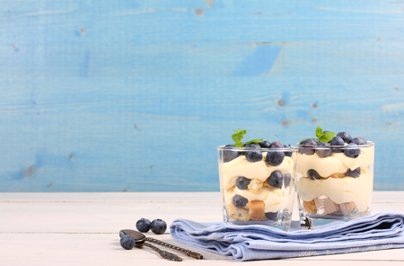 Fresh blueberry layered desert with mascarpone cream and cookies in glassの写真素材