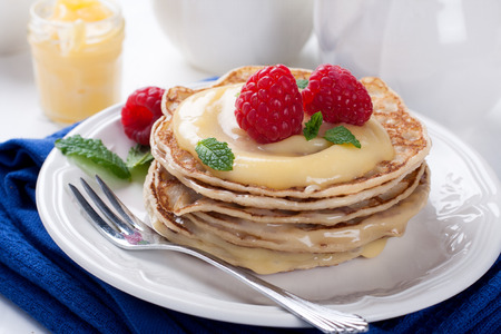 Stack of pancakes with lime curd and raspberriesの写真素材